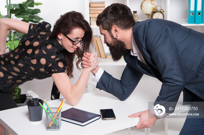 Gender equality. Career in business. Worthy rival. Underestimate forces. Equal rights. Feminism concept. Business competition. Business leadership. Man and woman tense faces compete armwrestling