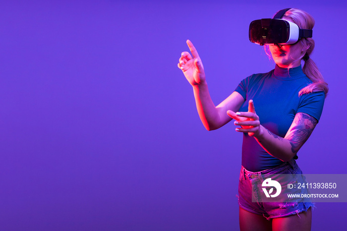 Woman experiencing virtual reality with a VR set on her head