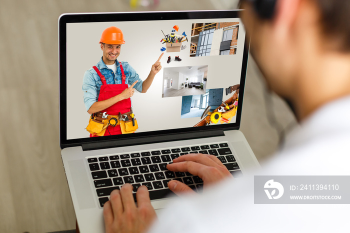 young manual worker displaying laptop over white background