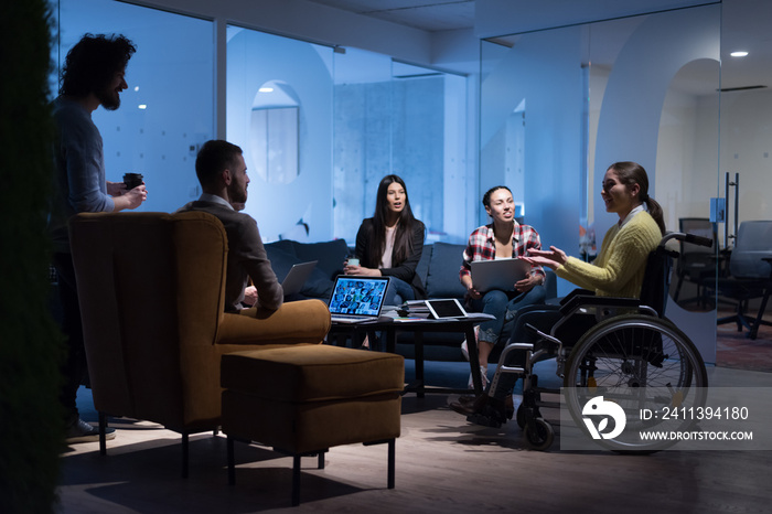 Handicapped young woman with colleagues working in office. She is smiling and passionate about the workflow. Performing in co-working space. Office people working together.