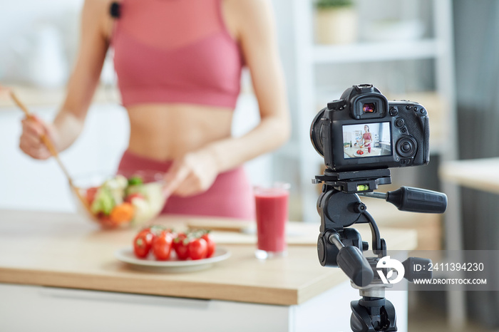 Close up of unrecognizable fit woman recording food video, focus on camera screen, copy space