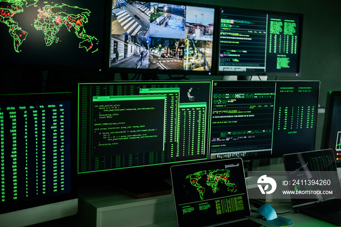 Computer monitor space with live camera views and multiple data located on dark room of hacker base