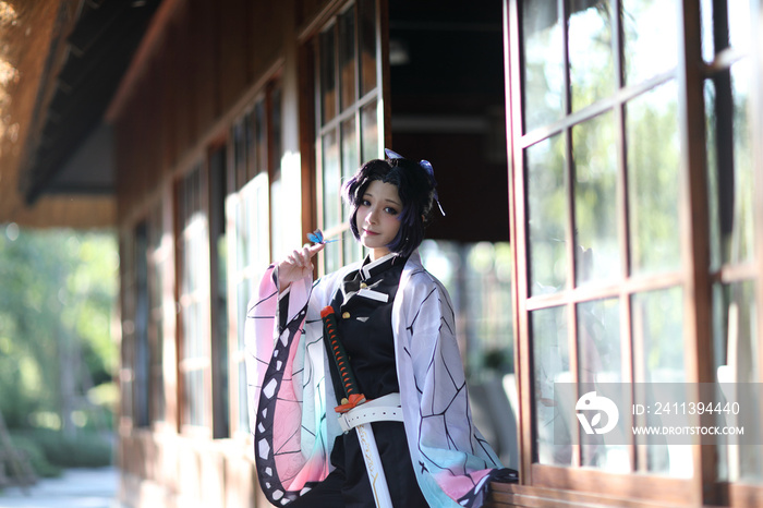 Japan anime cosplay portrait of girl with comic costume with japanese theme garden