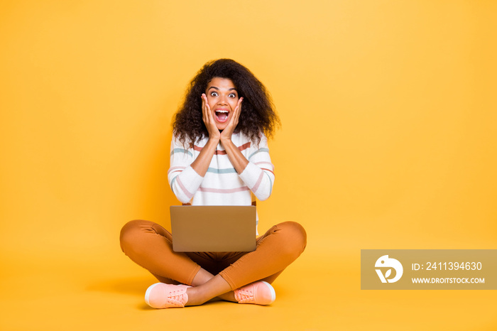 Portrait of her she nice attractive overjoyed glad cheerful wavy-haired girl sitting in lotus pose browsing web great news isolated on bright vivid shine vibrant yellow color background