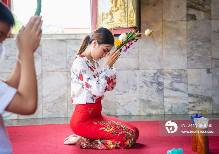 Beautiful Asian girl at big Buddhist temple dressed in traditional costume