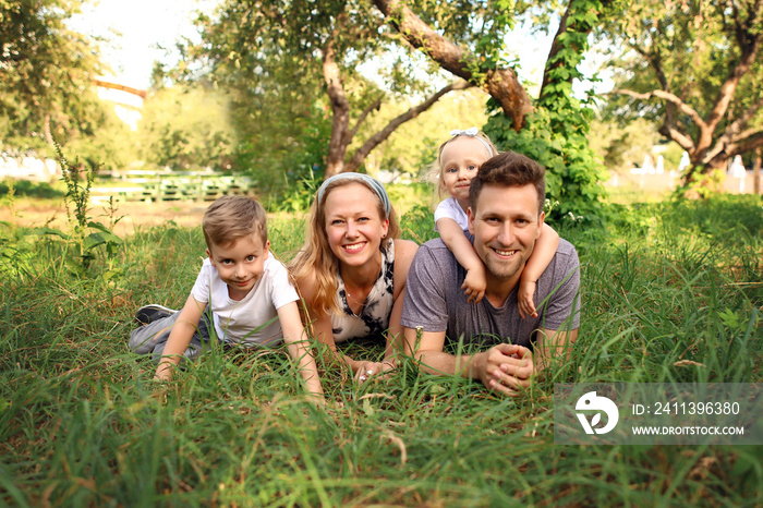 Happy loving family with two children, son and daughter playing and hugging. Family walk. Happy Mothers day.