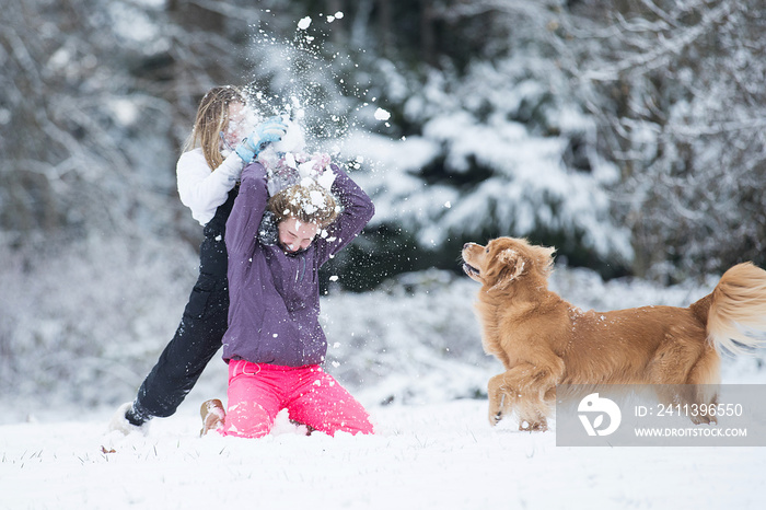 Child smashing snowball over another kids head during a white wi