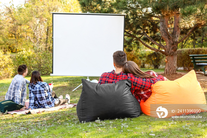 Friends watching movie in outdoor cinema