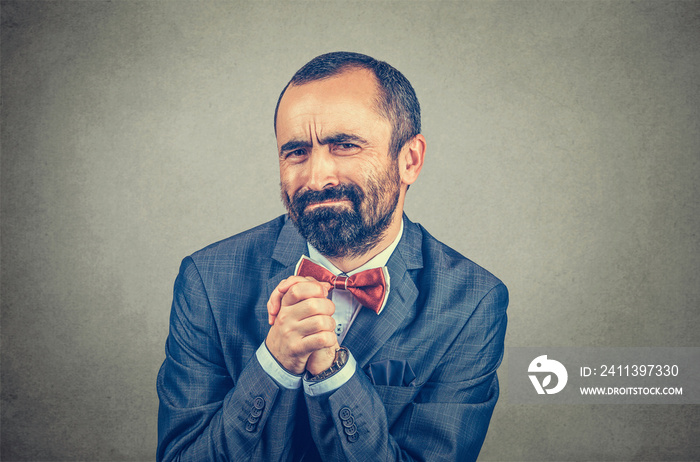 man showing clasped hands, pretty please isolated on gray background. Human emotion facial expression feelings, body language