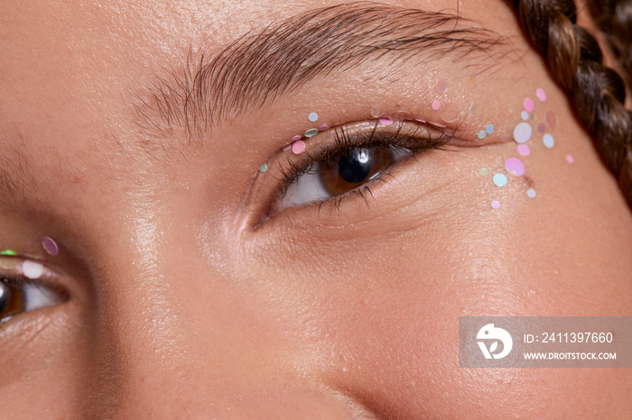 Close-up of smiling girl with decorative stickers on face