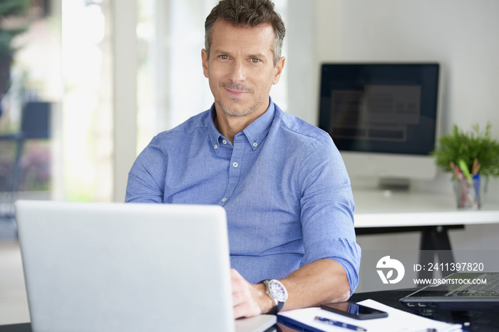 Businessman working on laptop at the office