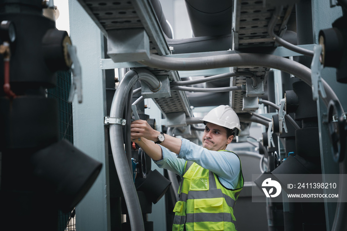 Engineers are inspecting a large building or industrial facility’s cooling system for the air conditioning.