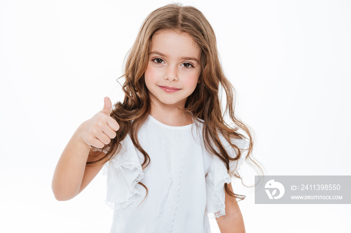 Happy cute little girl standing and showing thumbs up