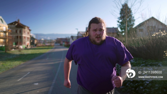 One overweight man starts to run outside getting back to into shape. Male big caucasian person running outdoors exercising body. Motivational discipline concept