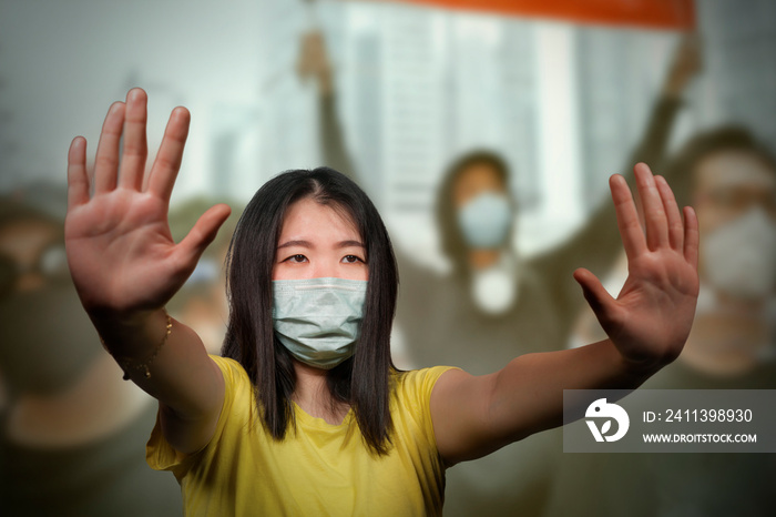 young beautiful pacifist Asian woman angry protesting on street demonstration standing for freedom and human rights showing clean hands as symbol of peace