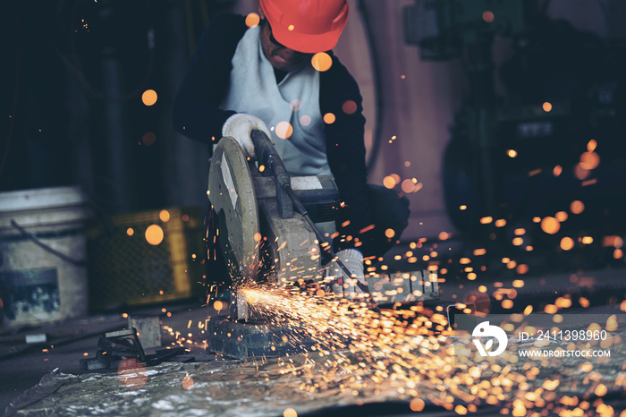 industrial engineer working on cutting a metal and steel with compound mitre saw with sharp, circular blade