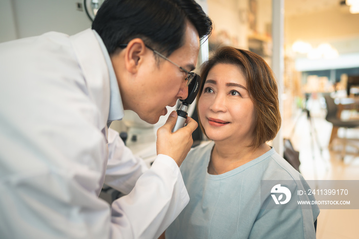 optometrist checking client eyes condition in optical store