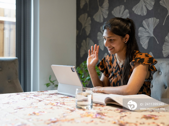 Woman working on tablet from home