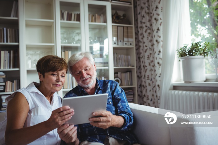 Senior couple using digital tablet