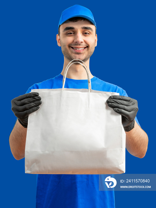 Delivery man with paper bag. Courier in uniform cap and t-shirt, gloves service fast delivering orde