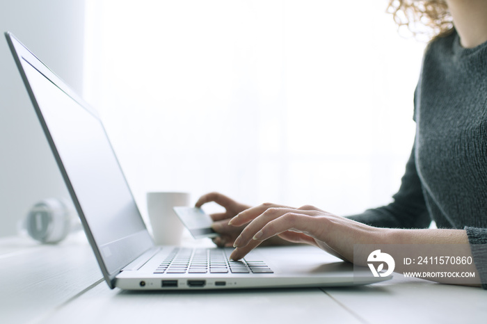 Woman doing online shopping with a credit card