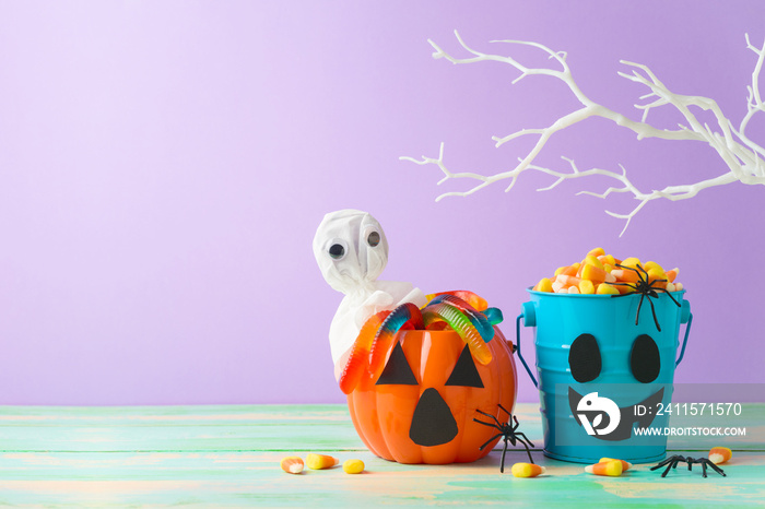 Halloween celebration concept with candy corn and candy in jack o lantern bucket for trick and treat