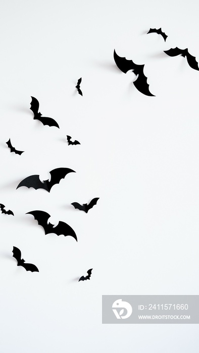 Closeup black paper bats on white wall,copy space,decor for holiday.Interior decoration concept for 