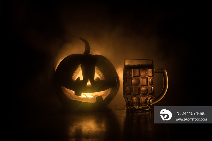 Glass of cold light beer with pumpkin on a wood background for Halloween. Glass of fresh beer and pu