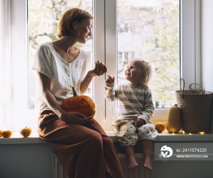 Happy family preparing for Halloween at home together.