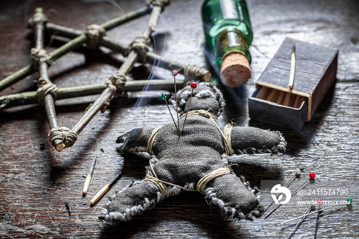 Strange voodoo doll pierced by a needle as harming