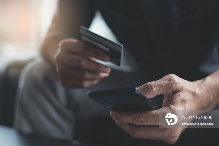 Man using credit card making internet payment for online shopping via mobile banking app on smartpho