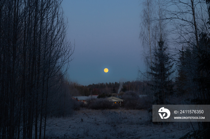 Rural landscape with old house and full moon