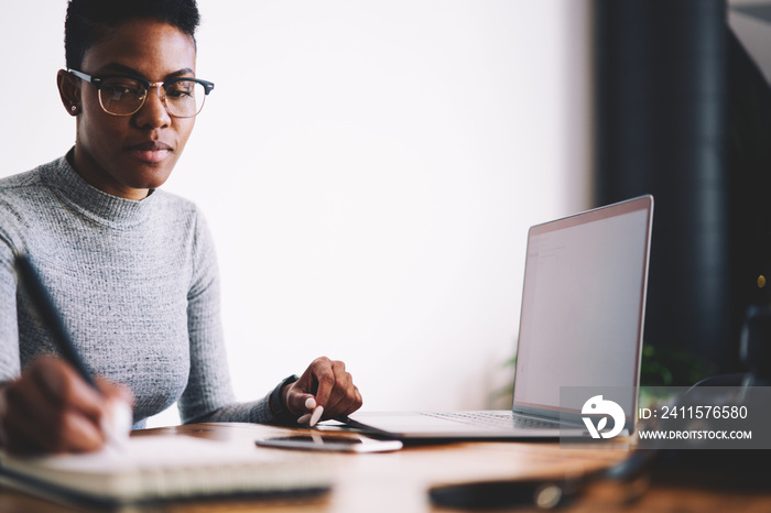 Prosperous afro american businesswoman concentrated on developing strategy for project making accoun