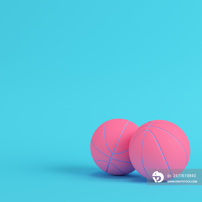 Pink basketball balls on bright blue background in pastel colors. Minimalism concept