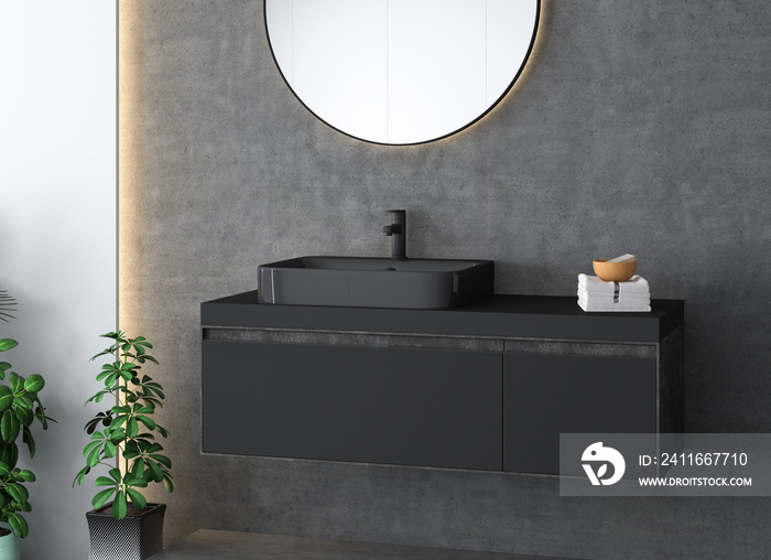 Black bathroom sink standing on a wooden bathroom furniture. A square mirror hanging on a concrete w