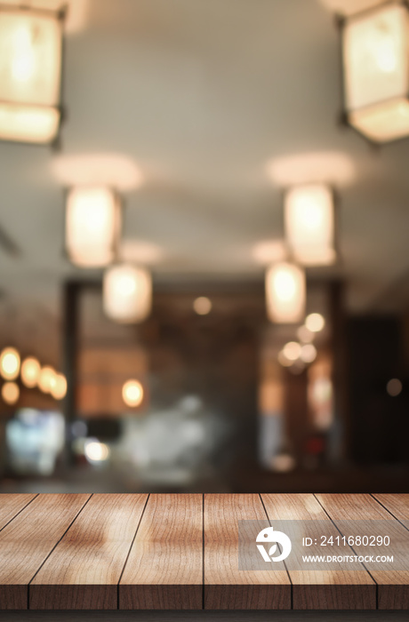 Wooden top table with bokeh light effect and blur restaurant on background, blur background.