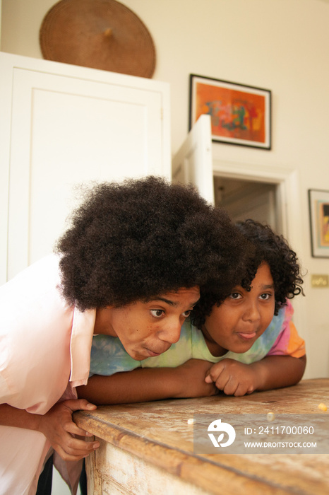 Two brothers being goofy and having fun in the kitchen