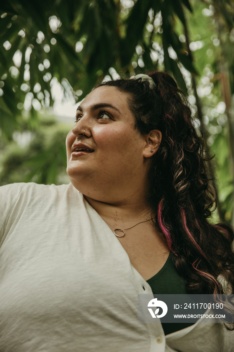 closeup of plus size woman surounded by plants