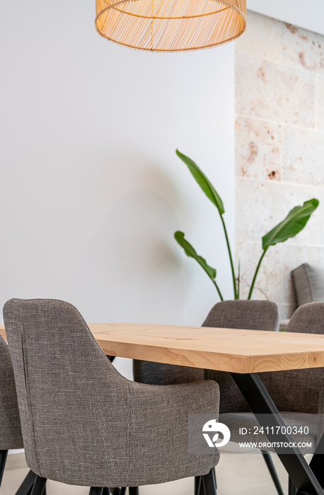 Hand made wooden table with four chairs and a lamp over it