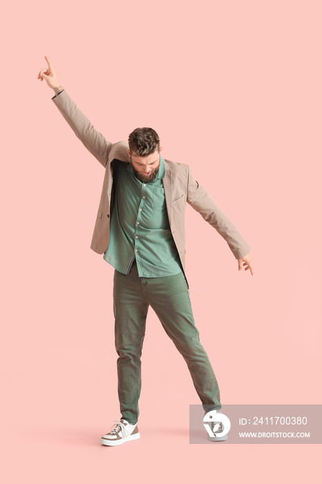 Cool dancing young man on color background