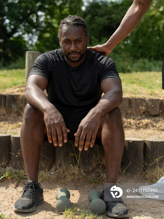 Two men resting after workout outdoors