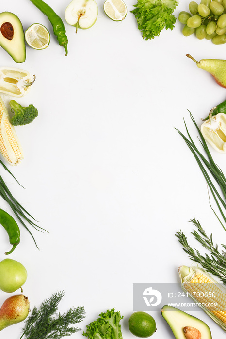 Assorted fresh vegetables and fruits in green on a white background. Top view. Copy space.