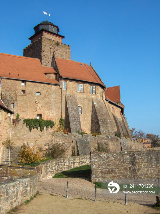 View of the youth hostel and Breuberg Castle. The old walls and the castle tower are surrounded by clear blue sky