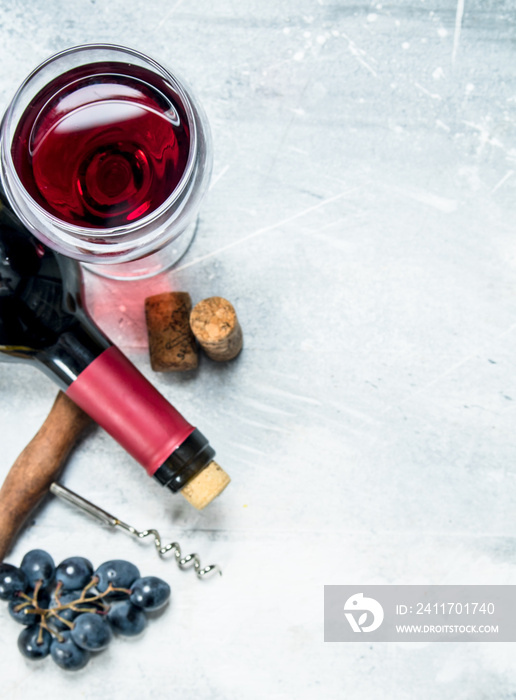 Wine background. Red wine with a grapes and a corkscrew.