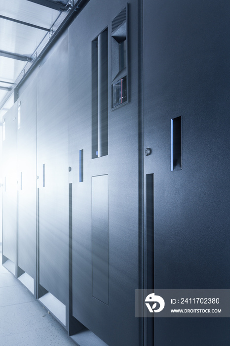 row of server cabinets inside data center room