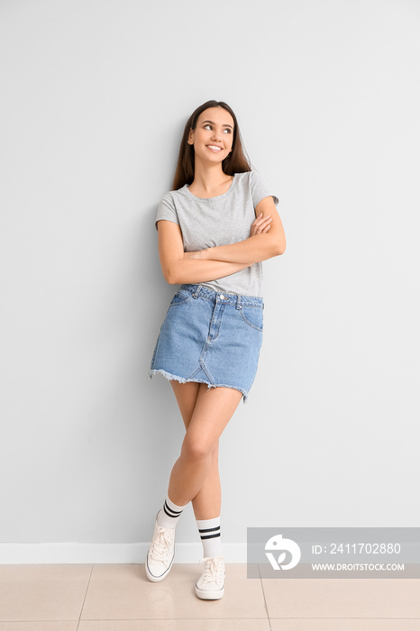 Pretty young woman in stylish t-shirt on light background