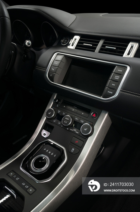 Modern luxury car control panel. Interior detail. Vertical photo.