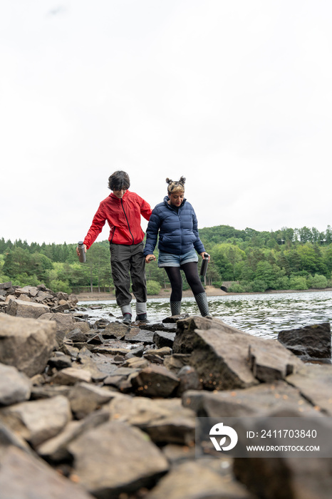 Mother and son wading in lake