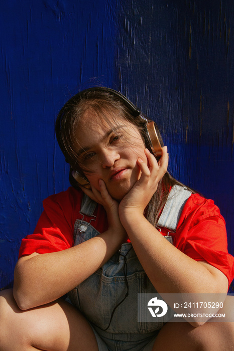 Young woman with Down Syndrome wearing headphones