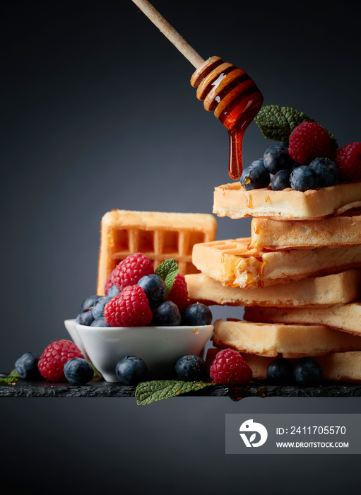 Belgian waffles with  blueberries, raspberries  and fresh mint.